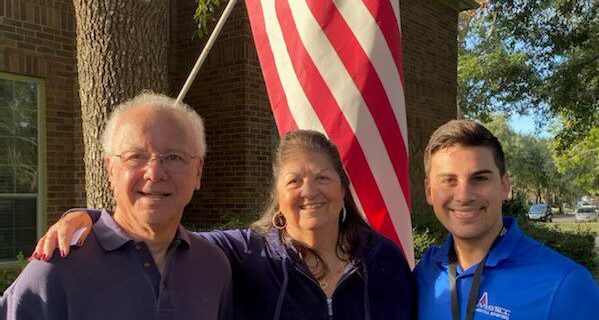 A photo of Stephen P. Hunten, wife, and Amstill Roofing representative.